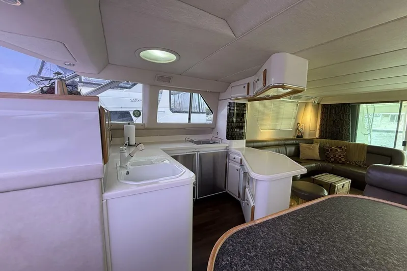  Yacht Photos Pics Interior of 1995 Sea Ray 550 Sedan Bridge yacht with modern kitchen and seating area.