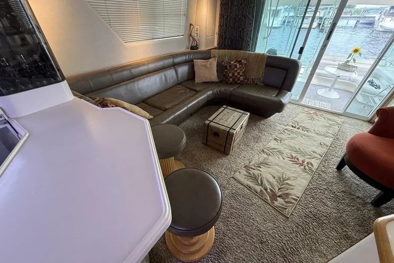  Yacht Photos Pics Luxurious interior of 1995 Sea Ray 550 Sedan Bridge with leather seating and waterfront view.