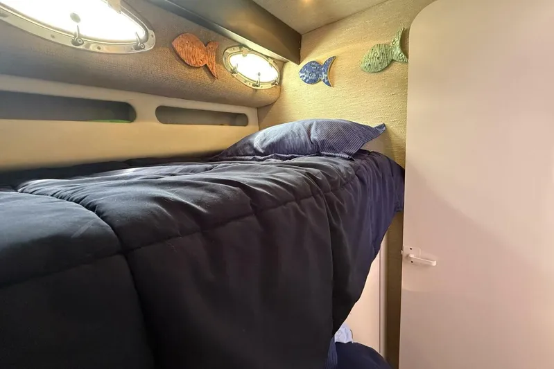  Yacht Photos Pics Cozy cabin interior of 1995 Sea Ray 550 Sedan Bridge with nautical decor.