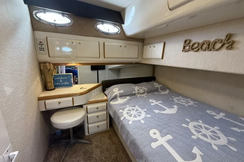  Yacht Photos Pics Cozy cabin interior of 1995 Sea Ray 550 Sedan Bridge with nautical-themed decor.