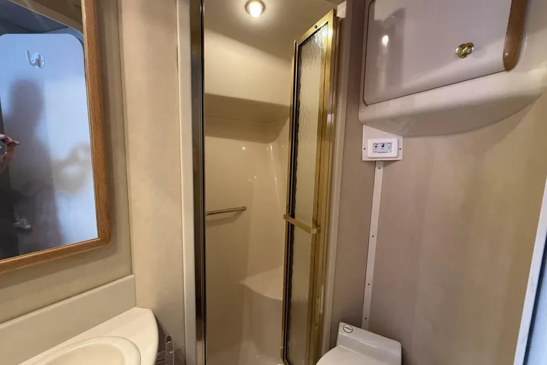  Yacht Photos Pics Bathroom interior of 1995 Sea Ray 550 Sedan Bridge yacht with shower and sink.