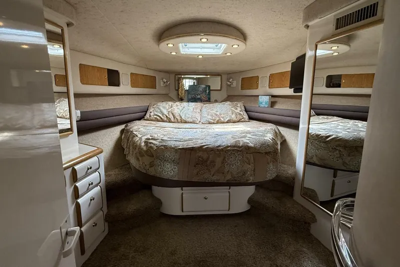  Yacht Photos Pics Luxurious 1995 Sea Ray 550 Sedan Bridge cabin interior with cozy bed and elegant decor.