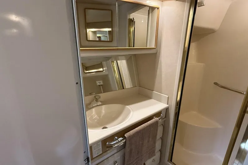  Yacht Photos Pics Bathroom interior of 1995 Sea Ray 550 Sedan Bridge yacht, featuring sink and shower.