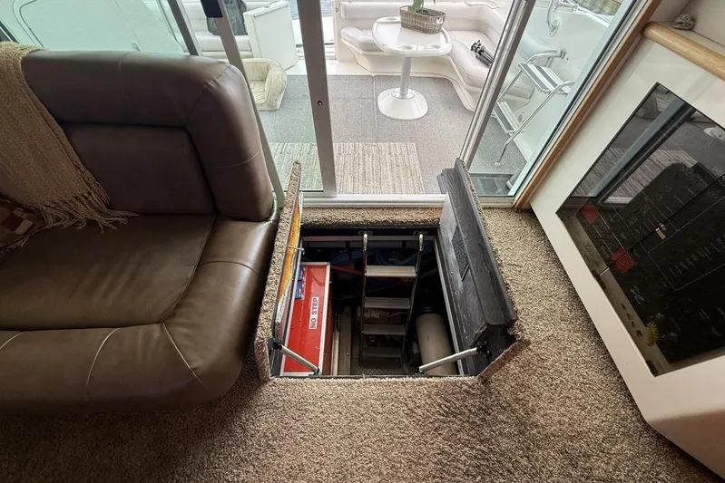  Yacht Photos Pics Interior of 1995 Sea Ray 550 Sedan Bridge with open hatch revealing storage compartment.