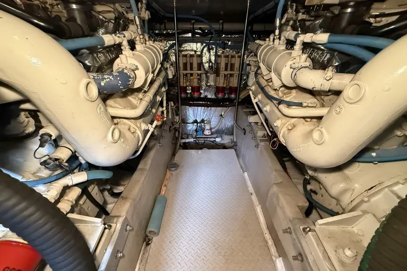  Yacht Photos Pics Engine room of a 1995 Sea Ray 550 Sedan Bridge, showcasing dual engines and piping.