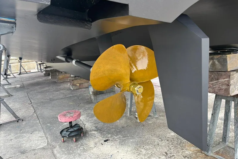 Perseus Yacht Photos Pics Propeller of 2004 Fleming 75 yacht on dry dock, showcasing hull and rudder.