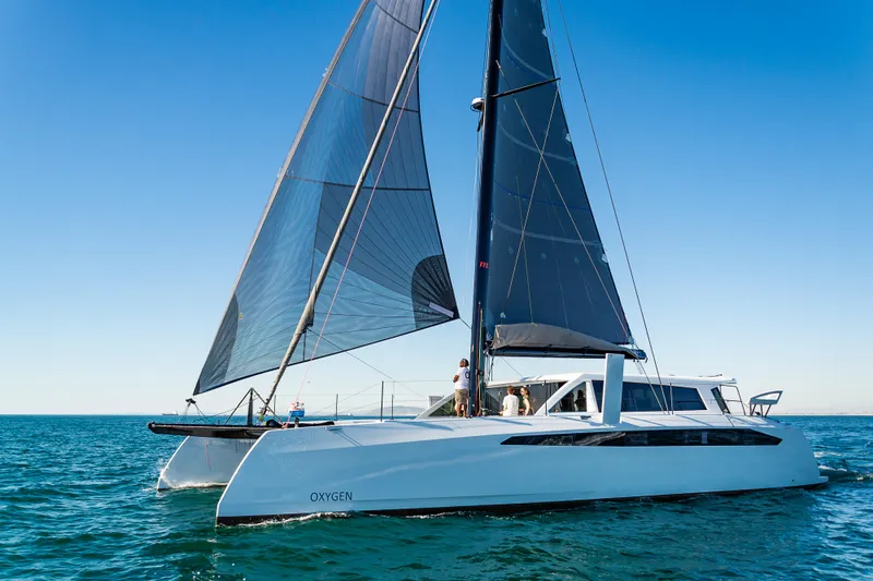  Yacht Photos Pics 2025 Ocean Renegade R6 catamaran sailing on open water.