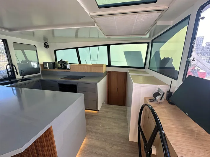  Yacht Photos Pics Modern interior of 2025 Ocean Renegade R6 yacht with sleek kitchen and navigation area.