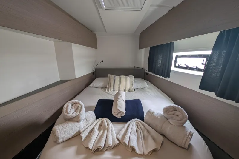 Maho Yacht Photos Pics Luxurious cabin interior of 2021 Fountaine Pajot Astrea 42 Catamaran with neatly arranged towels.