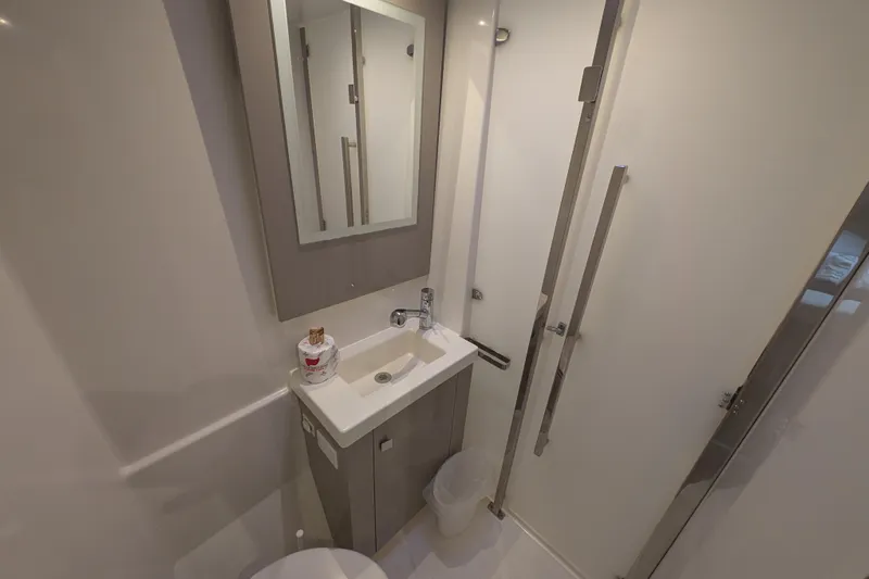 Maho Yacht Photos Pics Modern bathroom in 2021 Fountaine Pajot Astrea 42 Catamaran, featuring sleek sink and mirror.