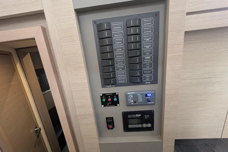 Maho Yacht Photos Pics Control panel of a 2021 Fountaine Pajot Astrea 42 Catamaran, featuring various switches and displays.