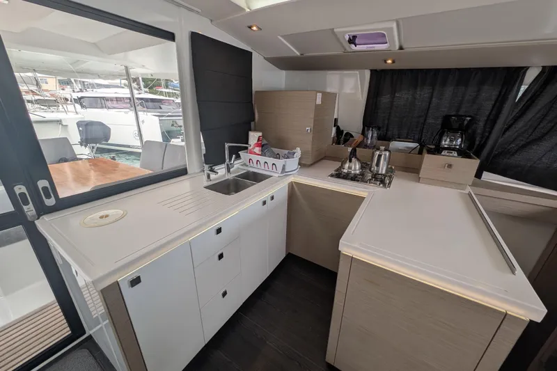 Maho Yacht Photos Pics Modern kitchen interior of 2021 Fountaine Pajot Astrea 42 Catamaran with sleek design.