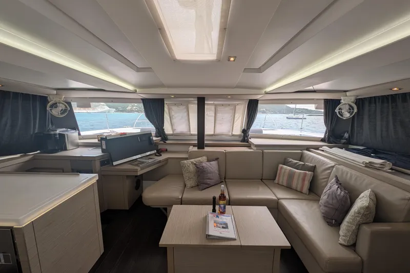 Maho Yacht Photos Pics Luxurious interior of 2021 Fountaine Pajot Astrea 42 Catamaran with modern seating and ocean view.