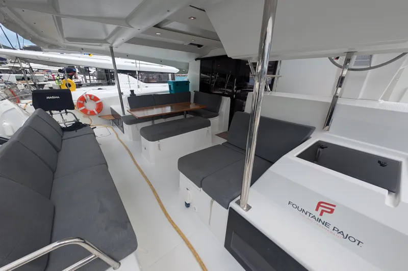 Maho Yacht Photos Pics 2021 Fountaine Pajot Astrea 42 Catamaran interior with seating and dining area.