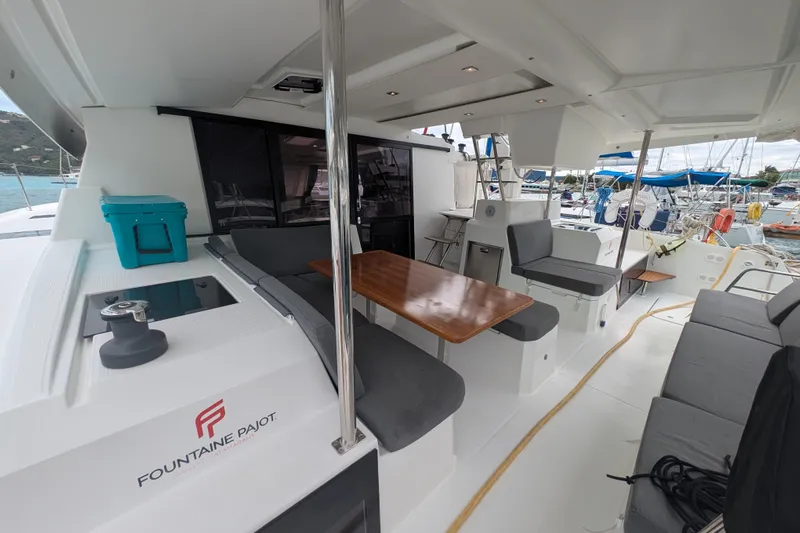 Maho Yacht Photos Pics 2021 Fountaine Pajot Astrea 42 Catamaran with spacious seating and dining area on deck.