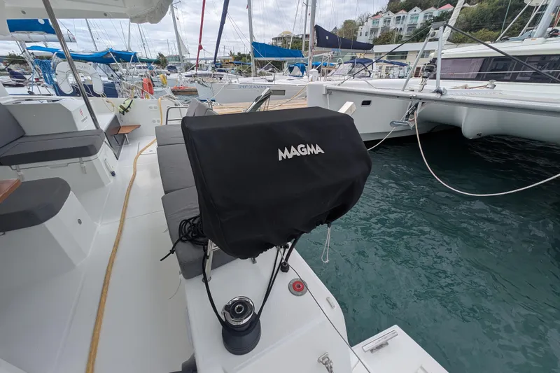 Maho Yacht Photos Pics 2021 Fountaine Pajot Astrea 42 Catamaran deck with covered Magma grill in marina.