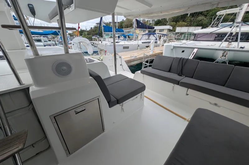 Maho Yacht Photos Pics 2021 Fountaine Pajot Astrea 42 Catamaran interior with seating and marina view.