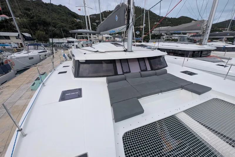 Maho Yacht Photos Pics 2021 Fountaine Pajot Astrea 42 Catamaran with spacious deck and seating area in marina.