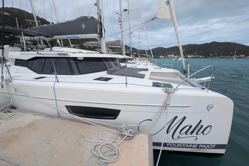 Maho Yacht Photos Pics 2021 Fountaine Pajot Astrea 42 Catamaran docked in a scenic marina.