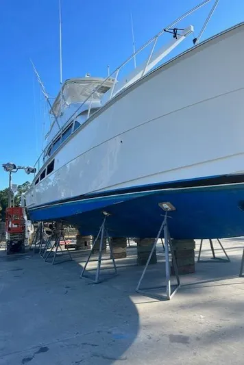  Yacht Photos Pics 2002 Hatteras 55 Convertible yacht on dry dock, side view.