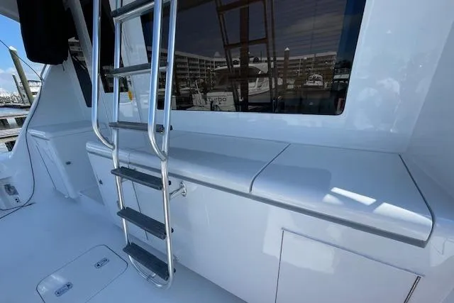  Yacht Photos Pics 2002 Hatteras 55 Convertible yacht deck with ladder and storage compartments.