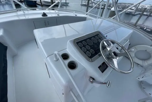  Yacht Photos Pics 2002 Hatteras 55 Convertible yacht helm with steering wheel and control panel.