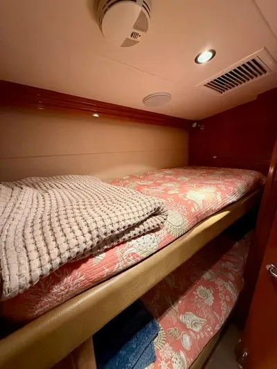  Yacht Photos Pics Cozy bunk beds in 2002 Hatteras 55 Convertible yacht cabin with floral bedding.