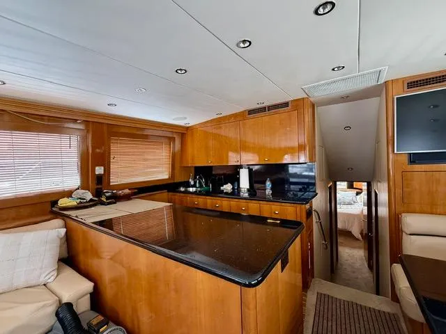  Yacht Photos Pics Interior of 2002 Hatteras 55 Convertible yacht with modern kitchen and cozy seating area.