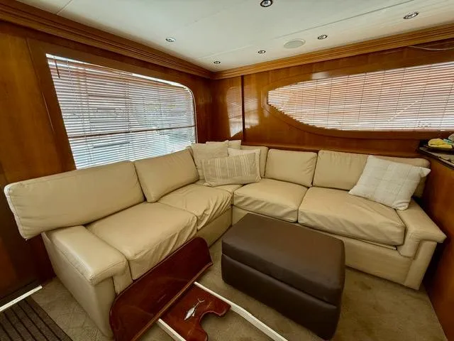  Yacht Photos Pics Luxurious interior of 2002 Hatteras 55 Convertible yacht with beige leather seating.