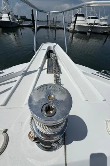  Yacht Photos Pics Bow of 2002 Hatteras 55 Convertible yacht with anchor windlass in marina.