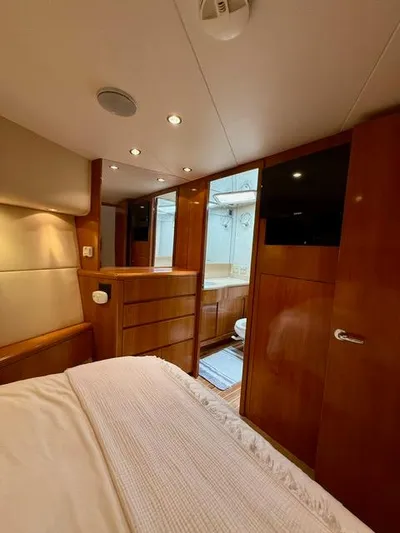  Yacht Photos Pics Luxurious cabin interior of 2002 Hatteras 55 Convertible yacht with wood finishes.