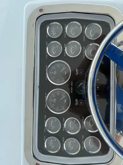  Yacht Photos Pics Instrument panel of a 2002 Hatteras 55 Convertible yacht with gauges and steering wheel.