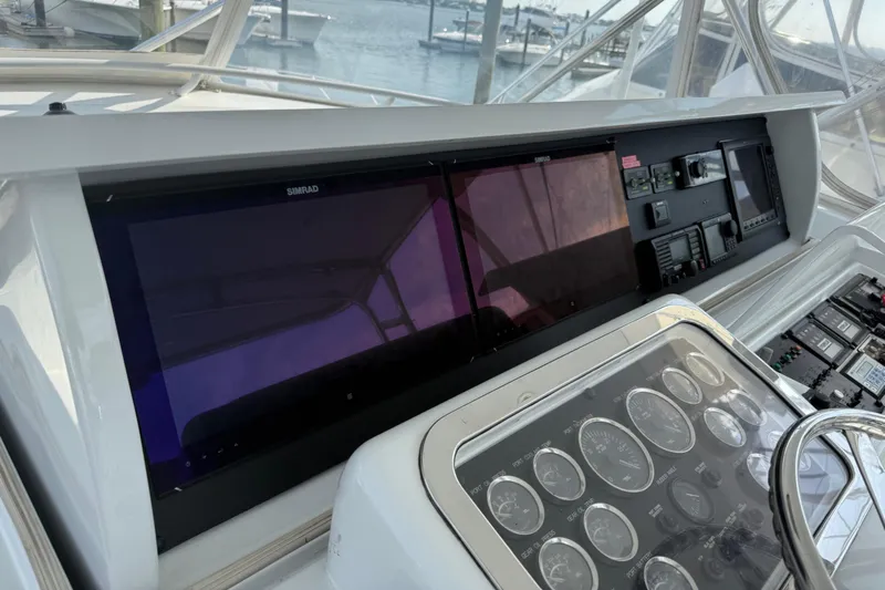  Yacht Photos Pics Control panel of a 2002 Hatteras 55 Convertible yacht with navigation screens.