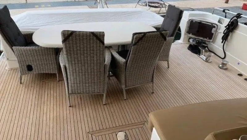  Yacht Photos Pics Outdoor seating area on a 2005 Posillipo 65 yacht with wicker chairs and table.