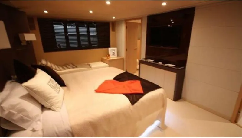  Yacht Photos Pics Luxurious bedroom interior on a 2005 Posillipo 65 yacht, featuring modern decor and ambient lighting.