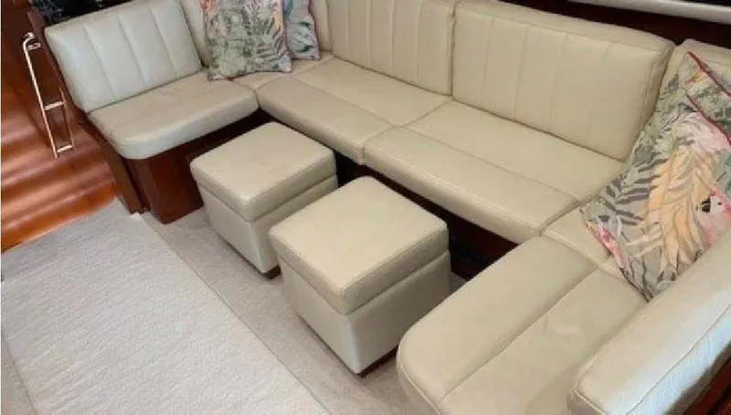 Yacht Photos Pics Luxurious interior of 2005 Posillipo 65 yacht with beige leather seating and floral cushions.