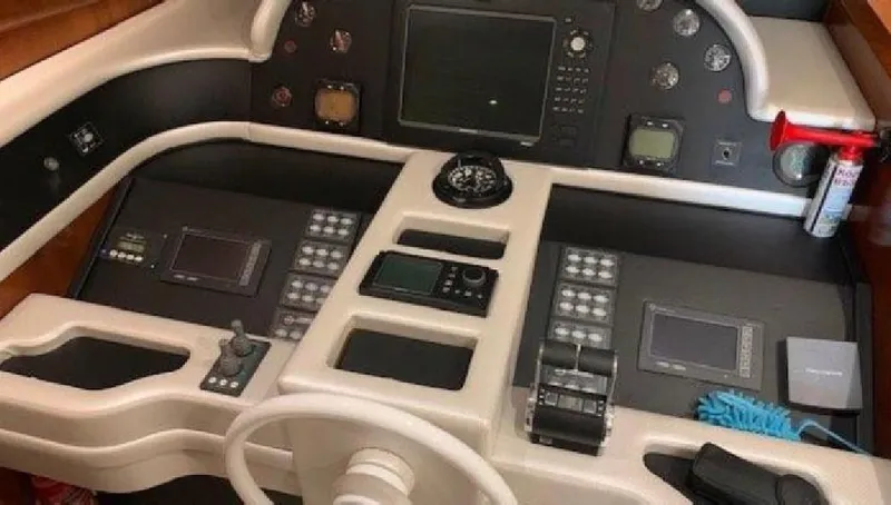  Yacht Photos Pics Control panel of a 2005 Posillipo 65 yacht with navigation instruments and steering wheel.