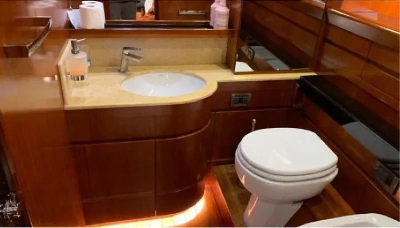  Yacht Photos Pics Luxurious bathroom interior of 2005 Posillipo 65 yacht with wooden cabinetry and modern fixtures.