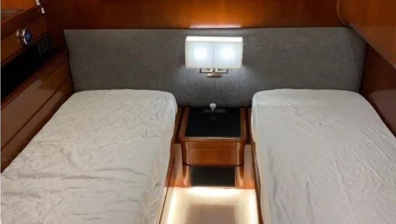  Yacht Photos Pics Twin beds in a 2005 Posillipo 65 yacht cabin with modern lighting and wooden accents.
