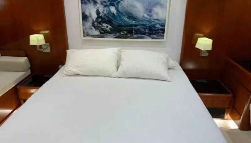  Yacht Photos Pics Luxurious bedroom interior on a 2005 Posillipo 65 yacht with elegant wood paneling.