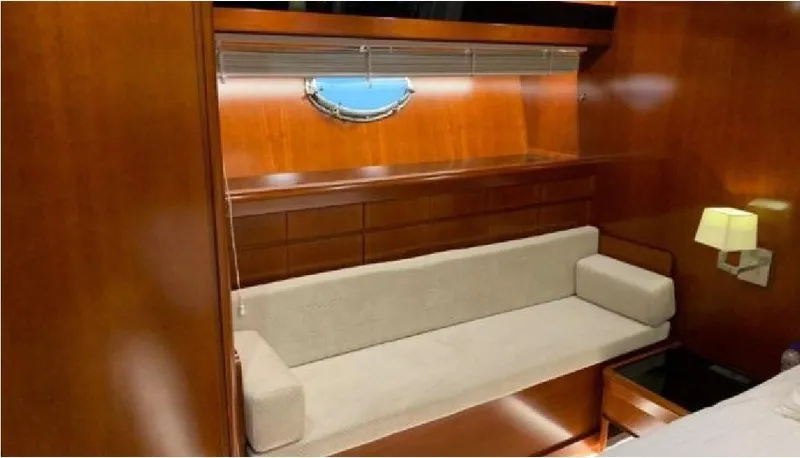  Yacht Photos Pics Luxurious interior of 2005 Posillipo 65 yacht with elegant wood paneling and beige sofa.