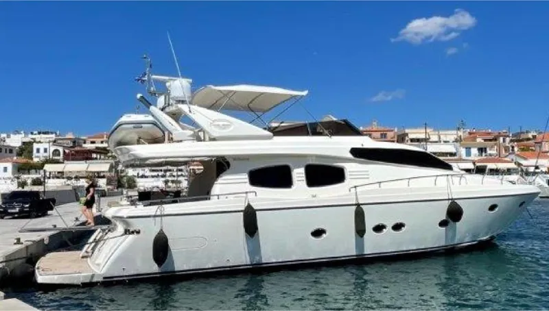  Yacht Photos Pics 2005 Posillipo 65 yacht docked at a marina under a clear blue sky.
