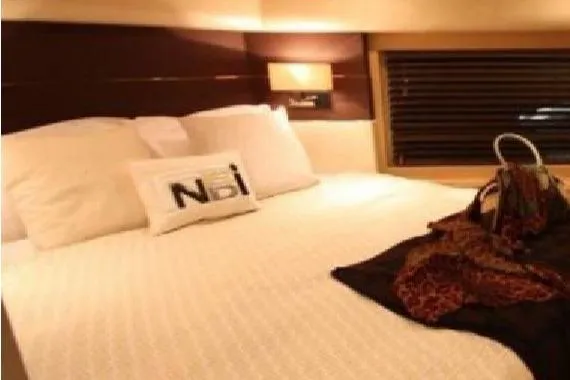  Yacht Photos Pics Luxurious bedroom interior on a 2005 Posillipo 65 yacht, featuring elegant bedding and ambient lighting.