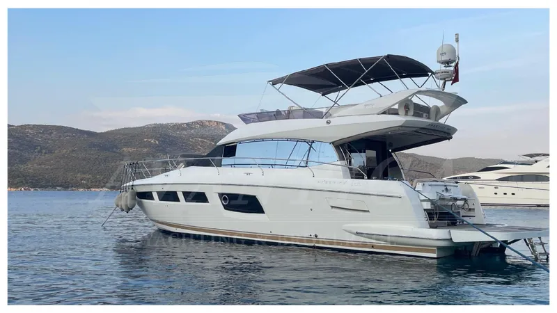  Yacht Photos Pics Luxury 2012 Prestige 500 yacht on serene water with scenic mountain backdrop.