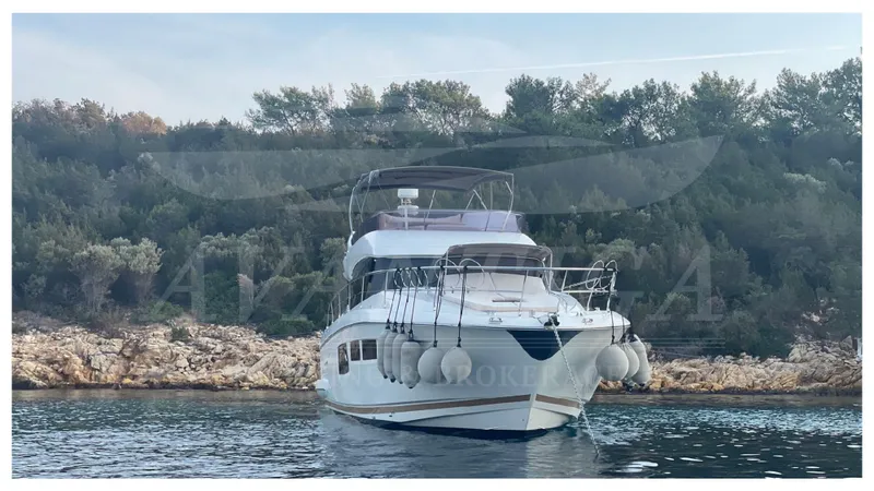  Yacht Photos Pics Luxury 2012 Prestige 500 yacht anchored near rocky shoreline.