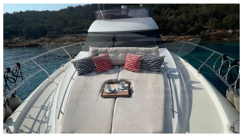  Yacht Photos Pics Luxurious 2012 Prestige 500 yacht with sunbathing deck, cushions, and scenic ocean view.
