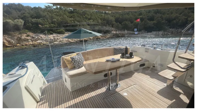  Yacht Photos Pics Luxurious 2012 Prestige 500 yacht deck with seating, table, and scenic coastal view.