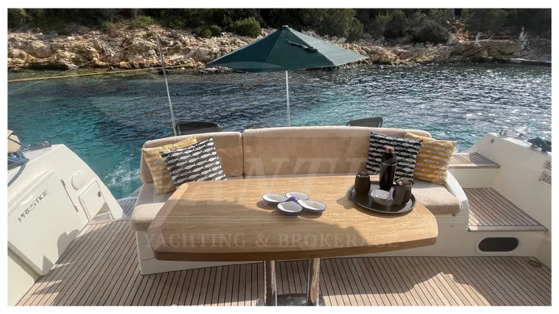  Yacht Photos Pics Luxury yacht deck with seating, table, and drinks, Prestige 500, 2012 model, scenic water view.