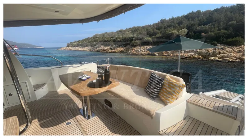  Yacht Photos Pics Luxurious 2012 Prestige 500 yacht deck with seating, table, and scenic coastal view.