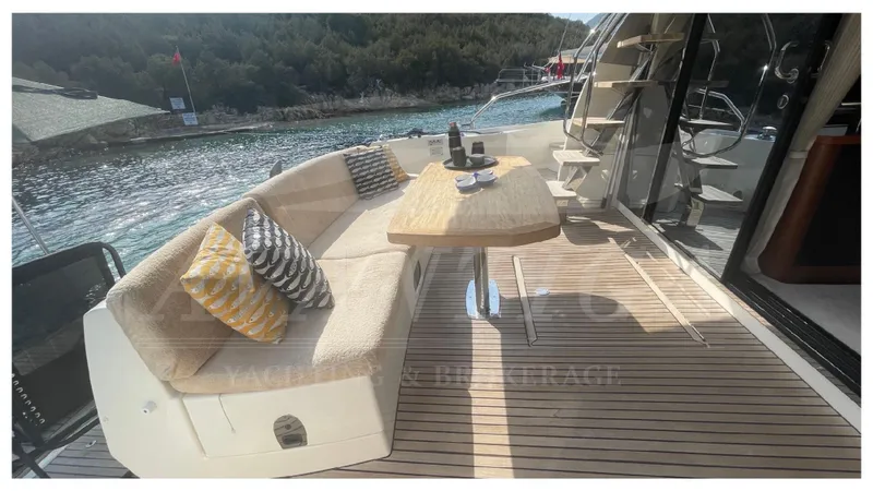  Yacht Photos Pics Luxurious 2012 Prestige 500 yacht deck with seating, table, and scenic water view.